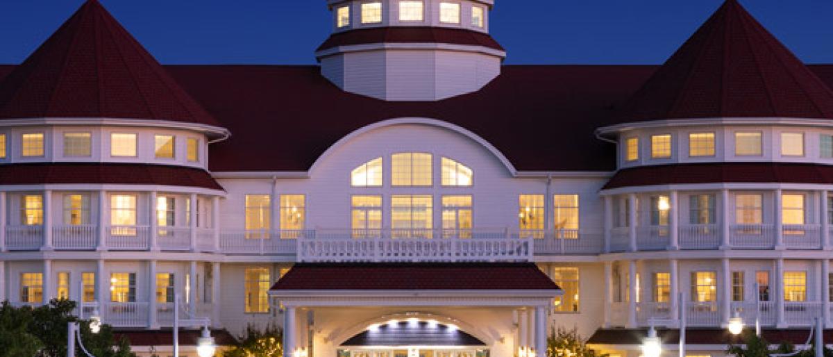 Blue Harbor Resort hotel exterior lit up at night with turret roofs