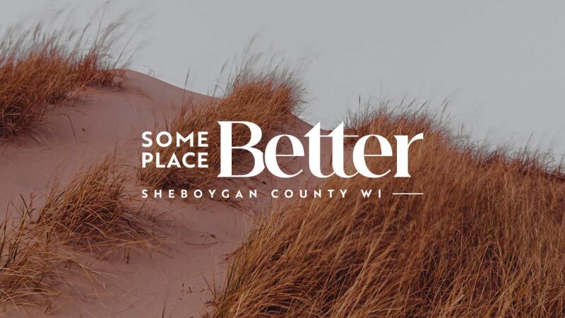 Some Place Better, Sheboygan County WI logo over a dune grass photo