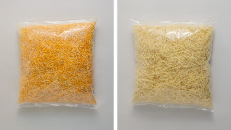 Two bags of shredded cheese, one cheddar blend and one mozzarella