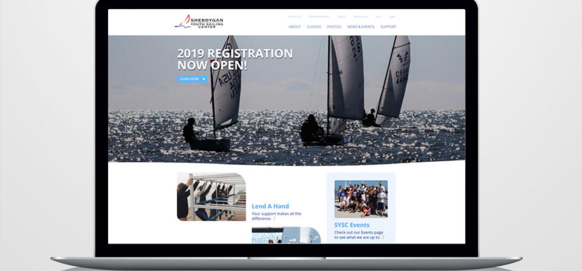 Sheboygan Youth Sailing Center website homepage showing sailboats racing on open water